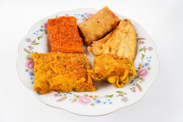 Variety of fried foods on plate isolated on white background
