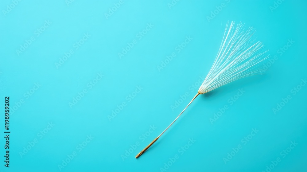 Poster close up of delicate golden dandelion seed against vibrant teal blue background with ample space for
