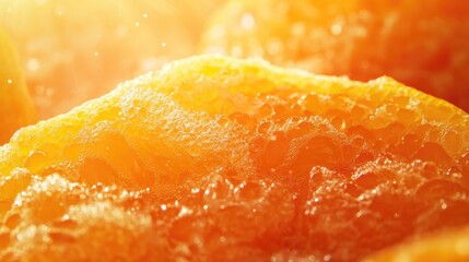 Sunlit close-up of fresh textured tangerines against a vibrant orange background with soft highlights creating a warm, inviting atmosphere.