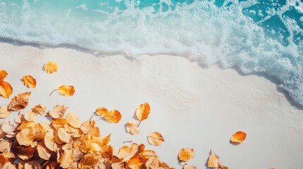 Naklejka premium Golden Autumn Leaves on Sandy Beach with Turquoise Waves and Clear Sky Perfect for Text Space in a Scenic Coastal Setting