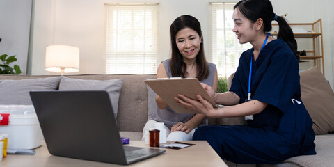 Elderly client receiving personalized care advice from caregiver during a consultation at home