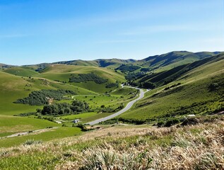 Fototapeta premium Scenic Winding Road Through Lush Green Hills