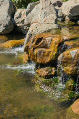 Japanese garden in Galitskrgo park in Krasnodar Triple waterfall. Close-up. Three streams with...