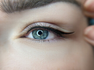 permanent eyeliner makeup close up. Healthy and clean skin young woman