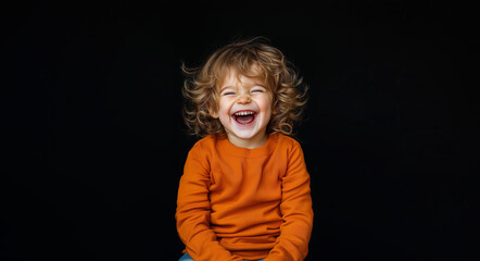 Toddler joyfully laughing with exuberance against a dark background, showcasing pure happiness and youthful spirit in a playful moment