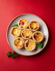 Freshly delicious mini quiches on red background