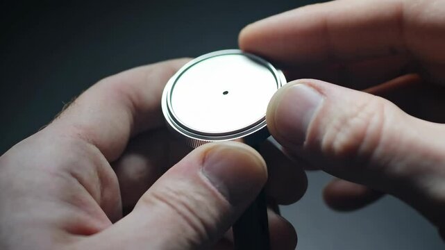 Detailed view of a person assembling a watch movement with precision and care in a workshop environment
