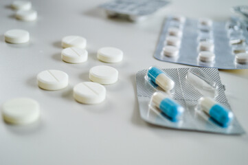 Assorted Blister Packs and Pills on a White Background