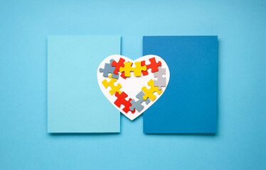 Autism Awareness Day, World Autism Day. Colorful and White Puzzles on Blue Background