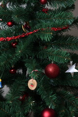 Christmas tree with red baubles and tinsel, festive holiday decoration close up