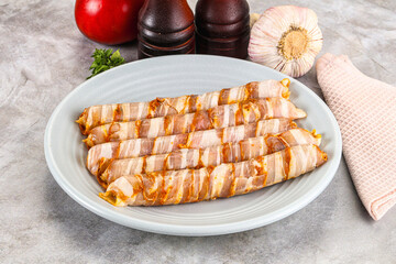 Raw sausages wrapped in bacon