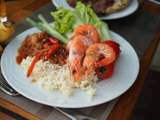 Thai shrimp with rice. King prawns, rice, lettuce. Seafood.