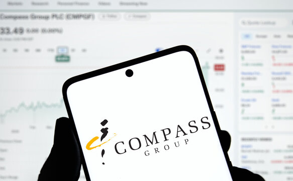 Dhaka, Bangladesh- 3 Dec 2024: Compass Group logo is displayed on smartphone.