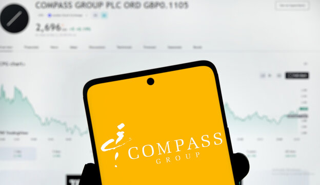 Dhaka, Bangladesh- 3 Dec 2024: Compass Group logo is displayed on smartphone.