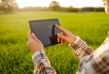 Farmers use agricultural technology in data analysis tablets. Women use tablets to research and...