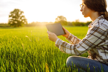 Farmers use agricultural technology in data analysis tablets. Women use tablets to research and...