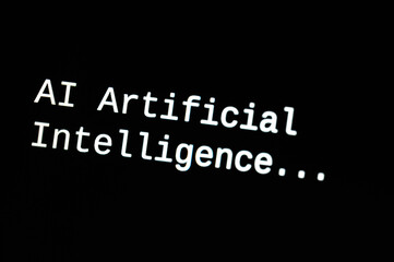 Black computer screen, with the text AI Artificial Intelligence. Use and evolution of artificial...