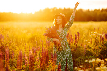Portrait of beautiful woman in amazing in a blooming field. Lavender field. Relax. Tourist. Lifestyle. Freedom. Travel.