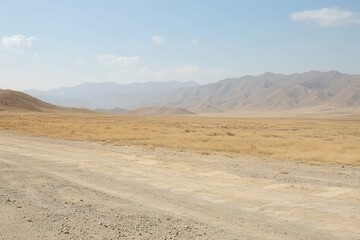 Expansive Desert Landscape Under Clear Sky with Mountain Range in the Distance, Highlighting Rugged Terrain, Dry Grass, and Natural Beauty of Arid Environment