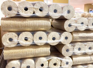 Wooden briquettes stacked for sale in a store display