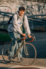 young man on the street riding on vintage bicycle