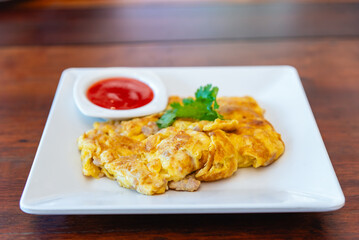 Omelet fried beaten eggs with chilli sauce,Thai traditional style eggs dish.
