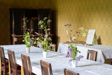  Floral arrangement with violet and white colored flowers. Summer flower arrangement of violet  columbines and blossoming lilac branches. Selective focus, details.