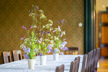  Floral arrangement with violet and white colored flowers. Summer flower arrangement of violet  columbines and blossoming lilac branches. Selective focus, details.