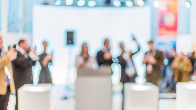 Product Launch Blur – A blurred background of a product launch event with attendees gathered around.	
