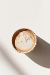 Elegant Latte Art Coffee in a Cup with Shadow on a Bright, Minimalist Background for Perfect Morning Refreshment