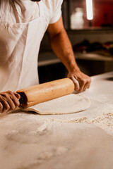 Man Hands Rolling Dough for Pizza
