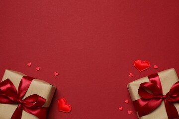 Beautiful gift boxes with red hearts on color background