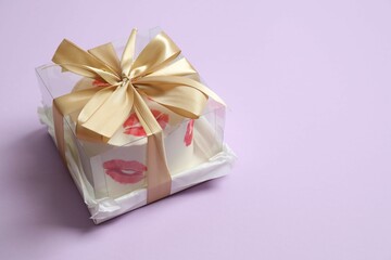 Colorful bento cake packed in a box with a bow on color background