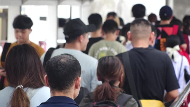 BANGKOK, THAILAND - AUGUST 2024 : View of crowd of people at the street. Locals and tourists in downtown area. Thai people, tourism and city life concept video. Slow motion shot.