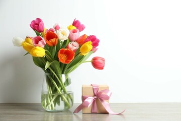 Fototapeta premium Gift box and beautiful fresh tulips in the vase