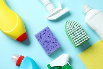 Many different cleaning products on color background, top view