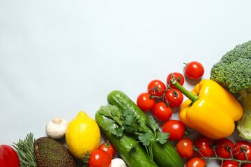 Clean healthy eating habits concept. Fruits, herbs, greens and vegetables mix, colorful juicy organic detox smoothie juice ingredients, gray background. Vegan vegetarian diet food