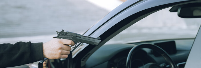 A robber with a gun and a mask attacked a female driver