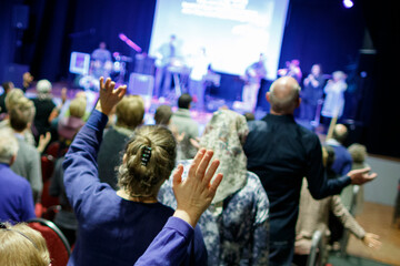 Evangelical church service with worshippers engaged in song and prayer in a vibrant community...