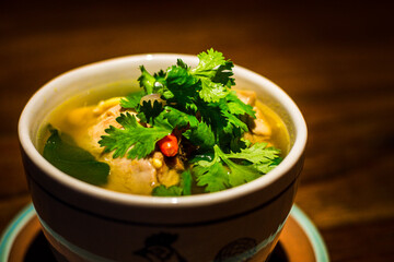Spicy soup of pork hock and pickled cabbage served in bowl
