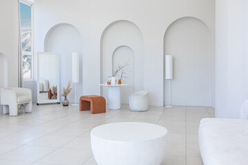 modern pure white interior design of a sprsious sitting room with soft stylish furniture. Large...