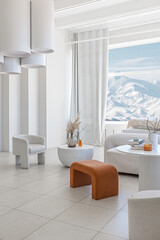 modern pure white interior design of a sprsious sitting room with soft stylish furniture. Large windows frame creating a serene atmosphere during daylight.