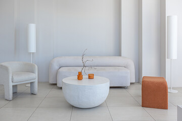 modern pure white interior design of a sprsious sitting room with soft stylish furniture. Large...