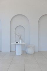 modern pure white interior design of a sprsious sitting room with soft stylish furniture. Large...