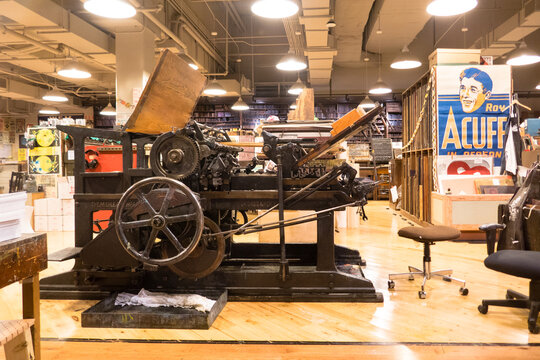 Nashville, TN - USA: Antique printing press in the workroom of Hatch Show Print with hanging poster on wall.