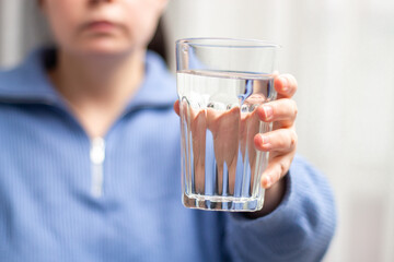 Close up image of woman holding glass of water. Concept of healthy lifestyle, beauty skin health...