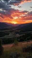 Fototapeta premium Vibrant sunset over a valley and mountains.