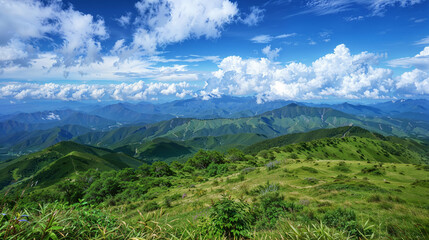 Obraz premium Expansive Green Hills and Cloud-Dotted Blue Sky A Scenic Vista of Rolling Landscapes