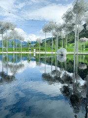 Swarovski museum outdoor installation reflecting on water with snowcapped mountains in the backgroun