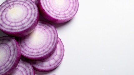 Close-up view of vibrant red onion rings arranged artistically on a clean white surface, showcasing their natural texture and color, ideal for culinary or food-related projects.